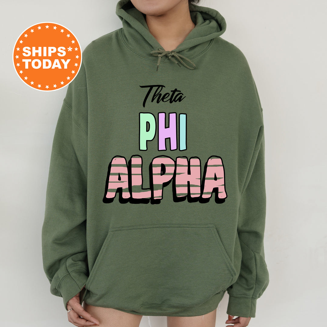 a person wearing a green hoodie with the words phi alpha printed on it