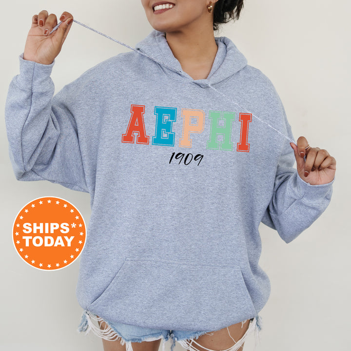 a woman wearing a blue hoodie with the word aeph on it