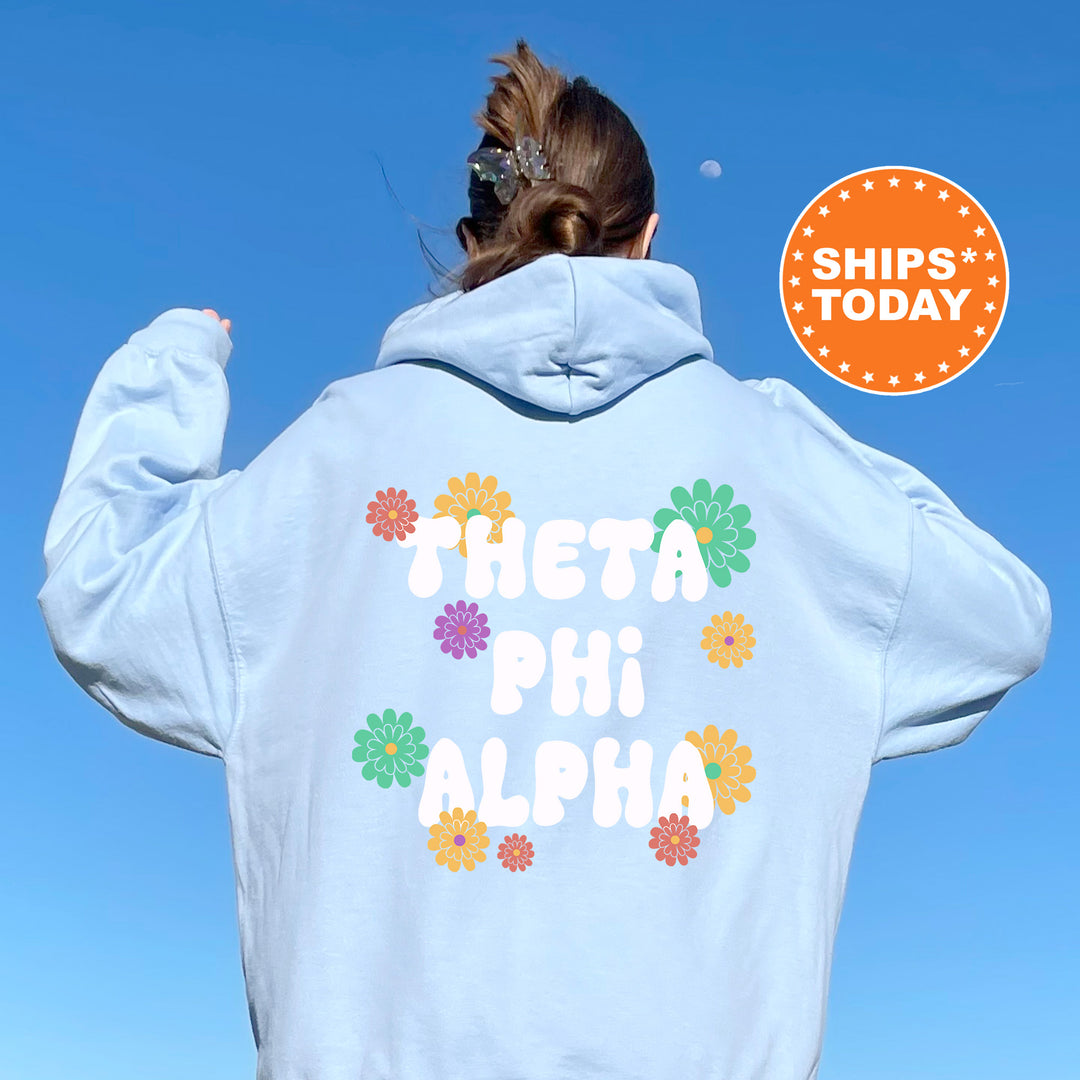 a woman wearing a white hoodie with the words thea phi aloha