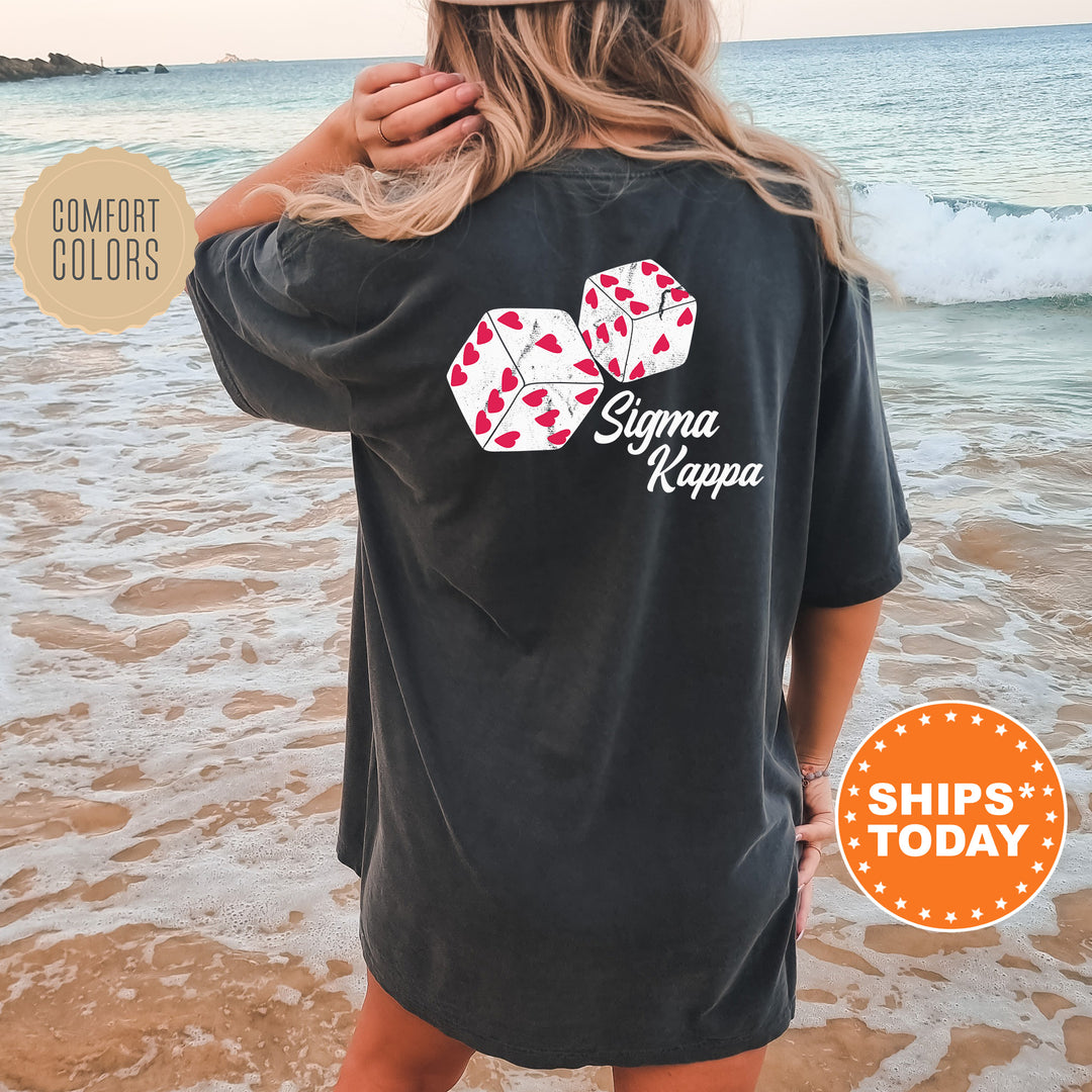 a woman standing on a beach wearing a black shirt