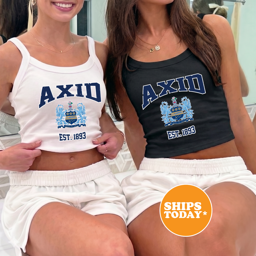 Two women wearing tank tops with the word "AXID" printed on them, posing together.