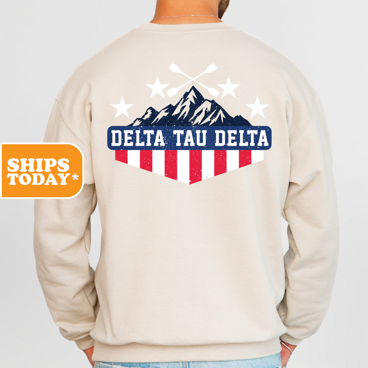 a man wearing a sweatshirt with the words delta tau delta on it