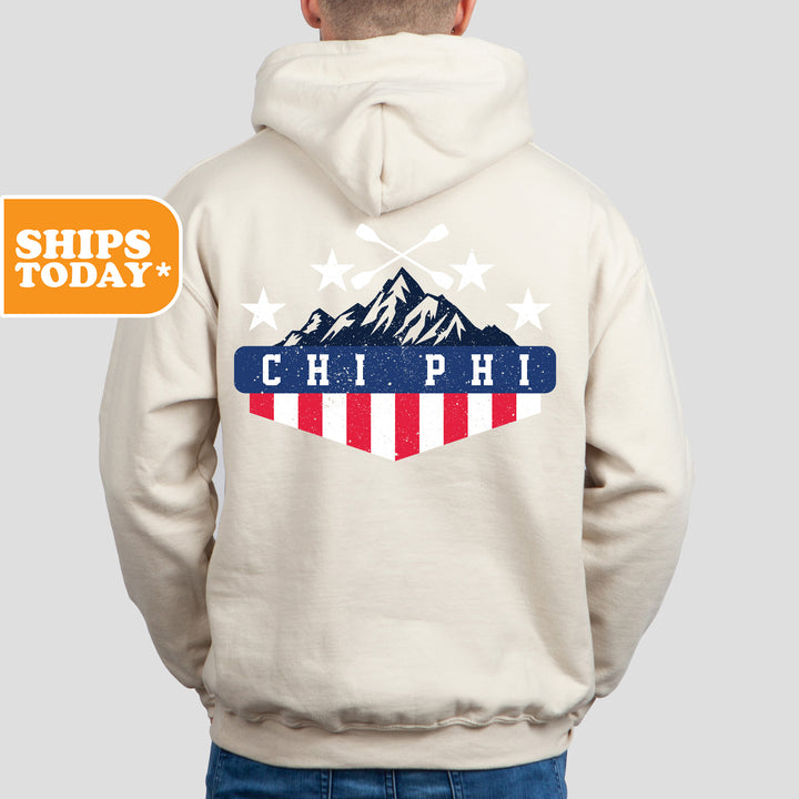 a man wearing a white hoodie with a mountain and stars on it
