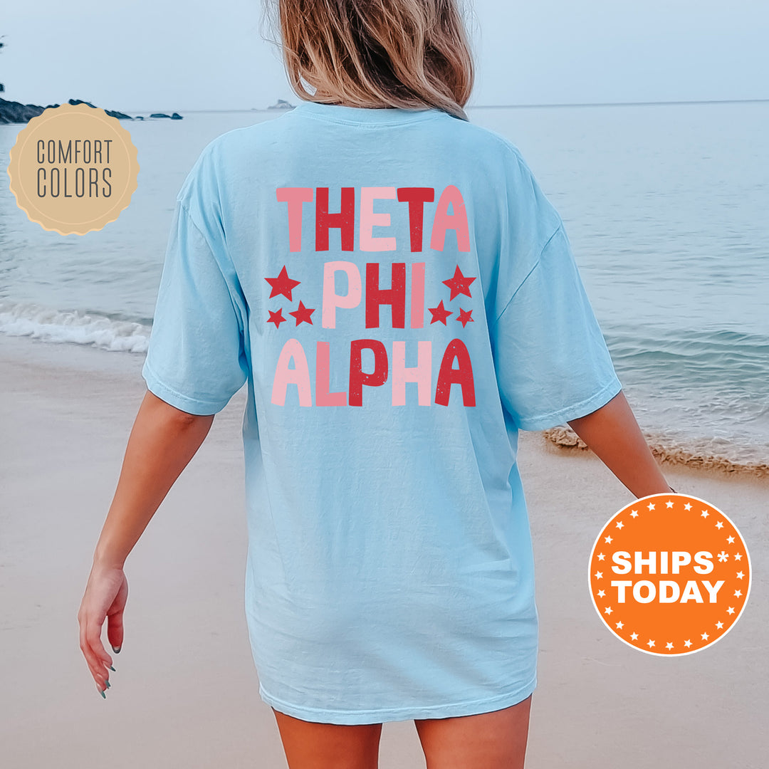 a woman walking on the beach in a blue shirt