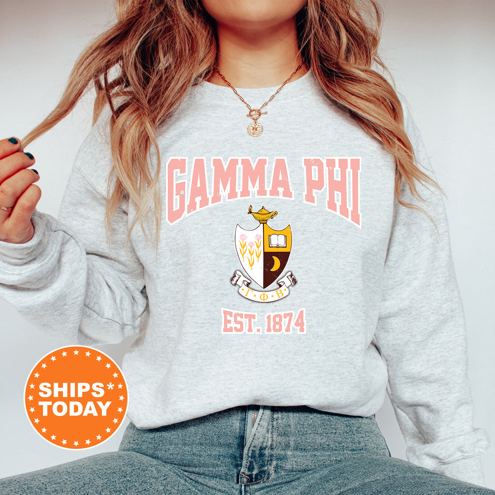 a woman wearing a sweatshirt with the words gama phi on it