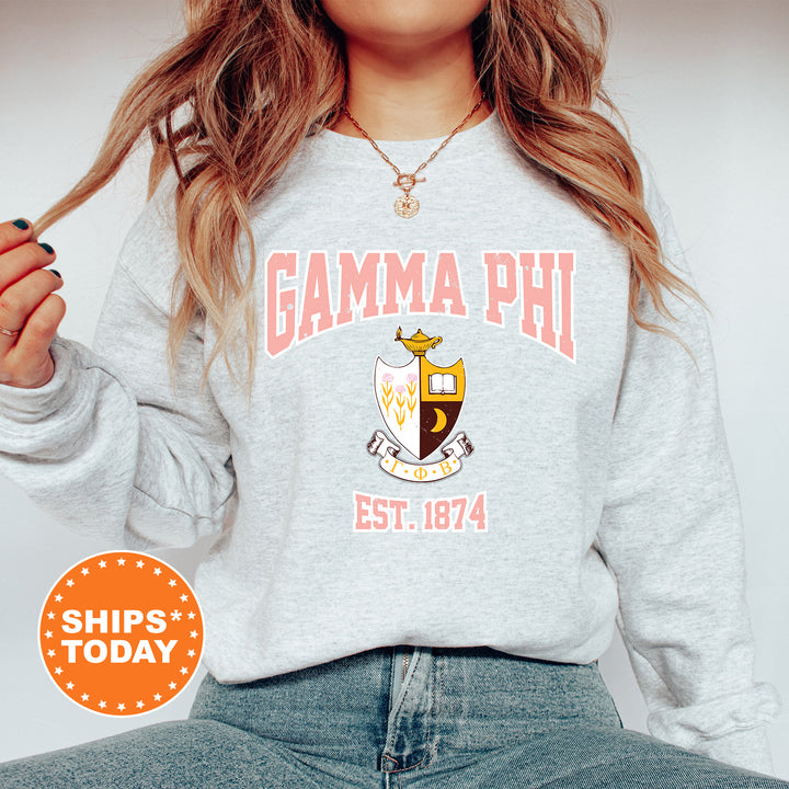 a woman wearing a sweatshirt with the words gama phi on it