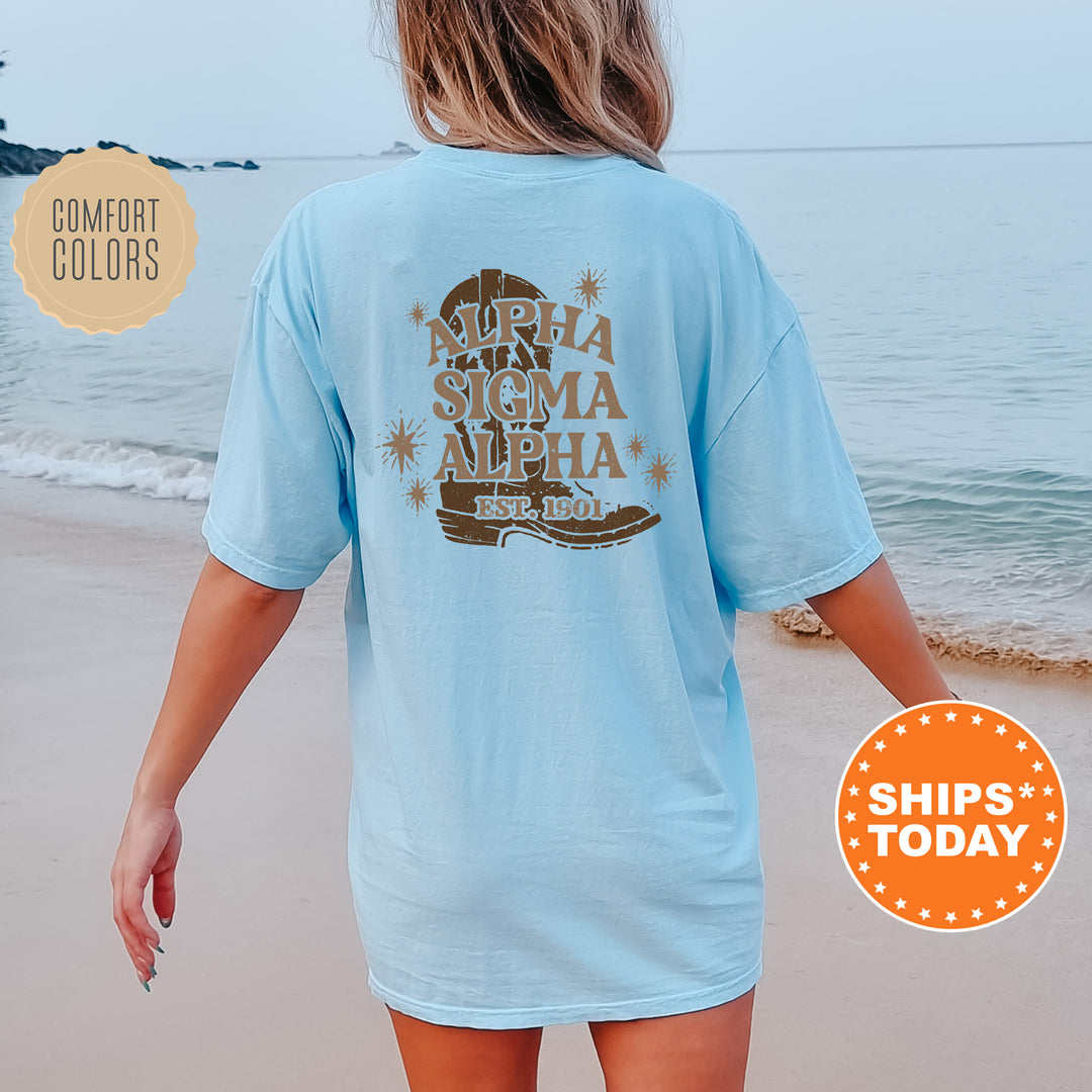 a woman walking on the beach wearing a light blue shirt