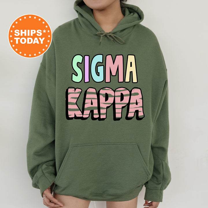 a woman wearing a green hoodie with the words stigma kappa on it