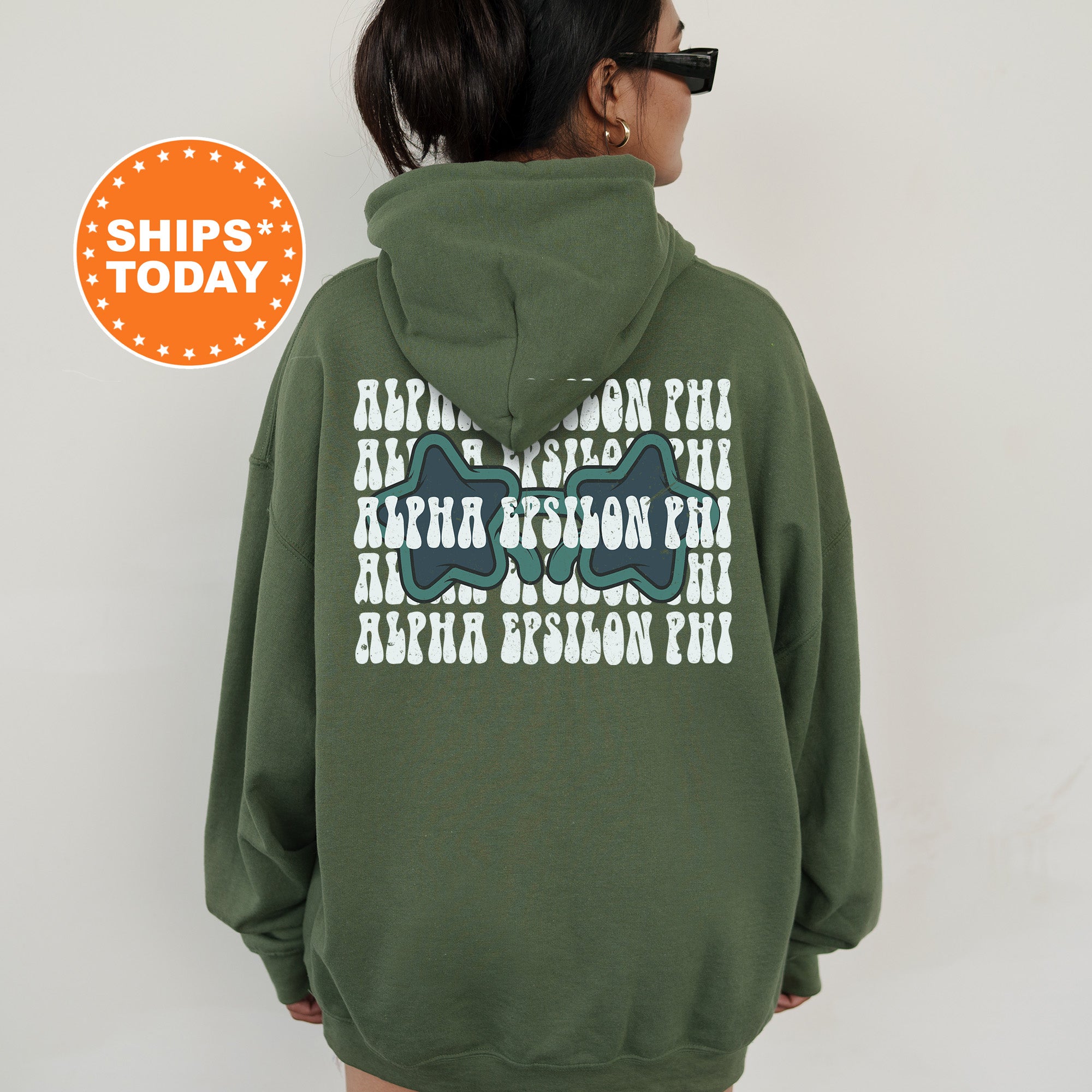 a woman wearing a green hoodie with an image of a dinosaur on it