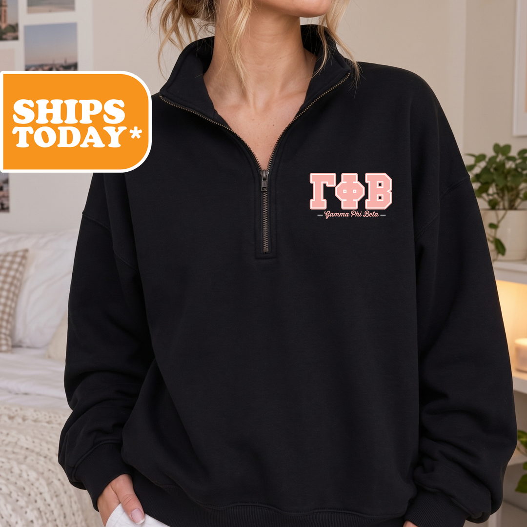 A person wearing a black sweatshirt with the letters 'TB' printed on it.