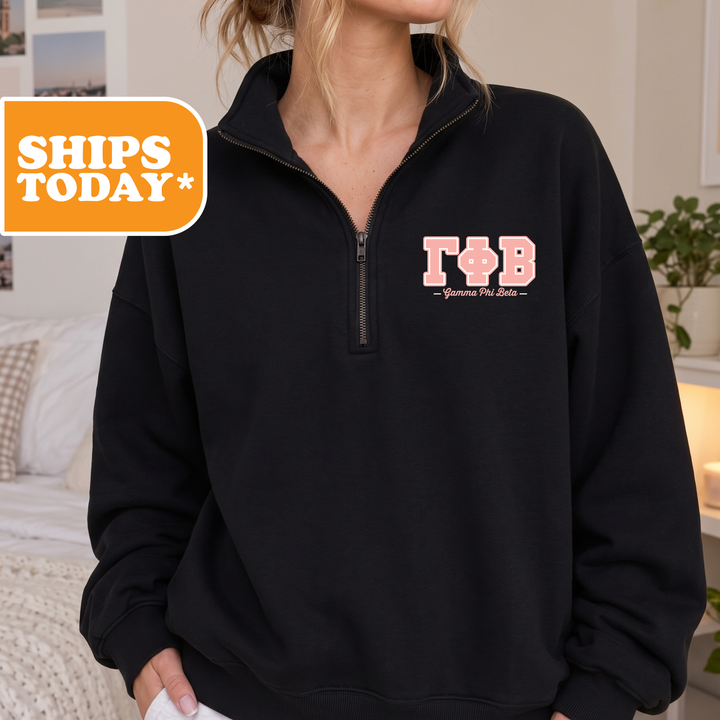 A person wearing a black sweatshirt with the letters 'TB' printed on it.