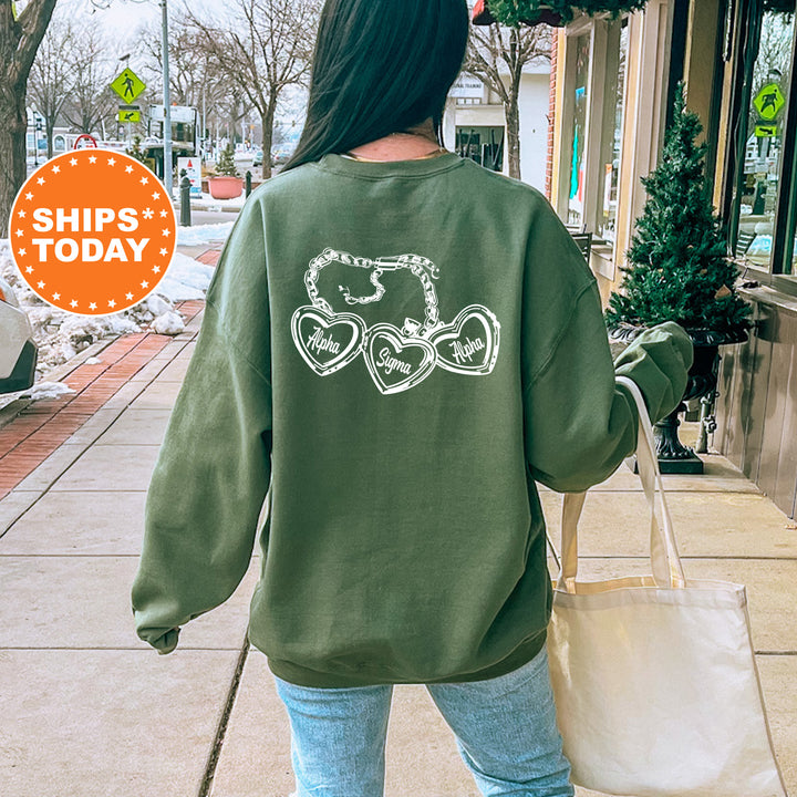 A person wearing a green sweatshirt with white text on the back is walking down a sidewalk, carrying a white bag.