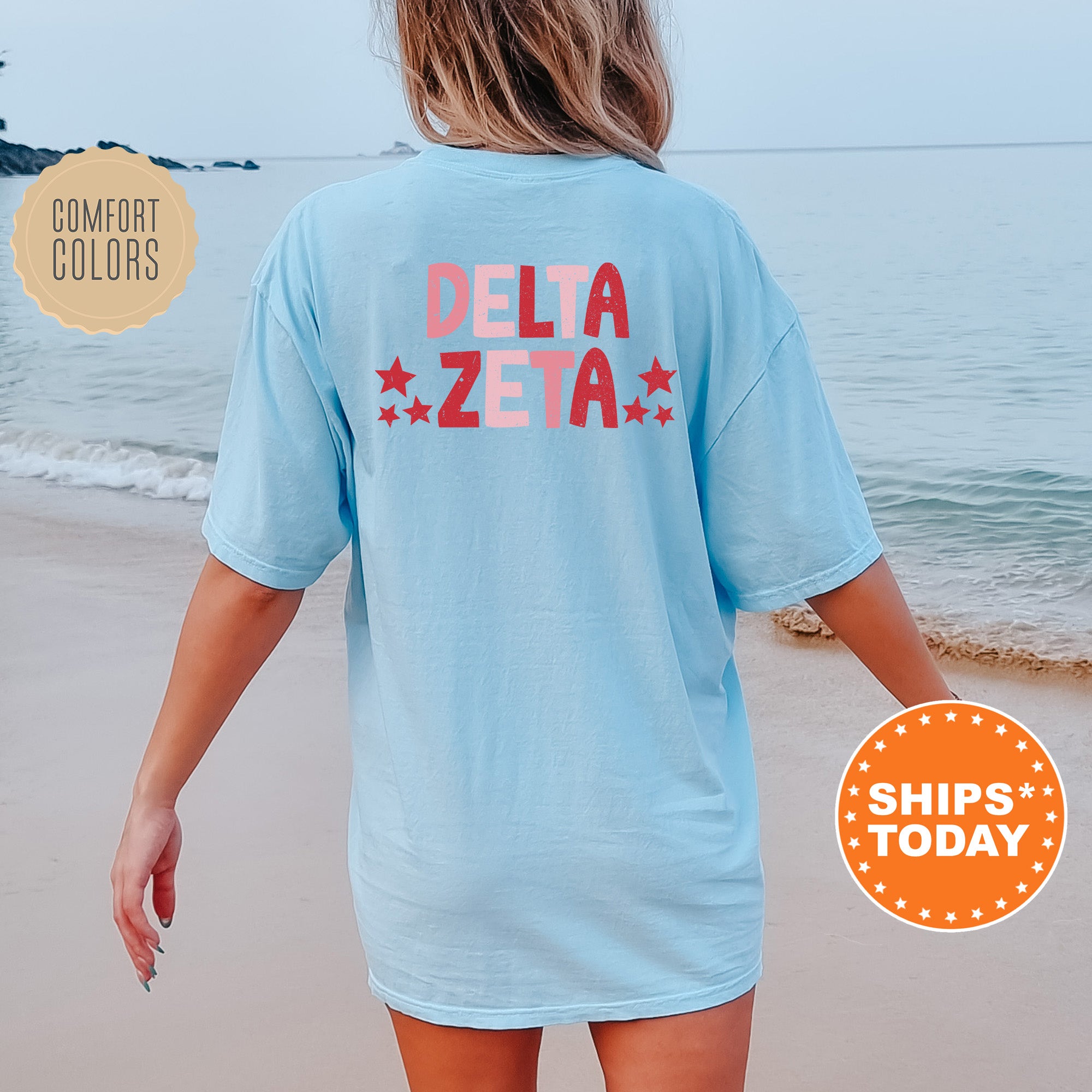 a woman walking on the beach in a blue shirt