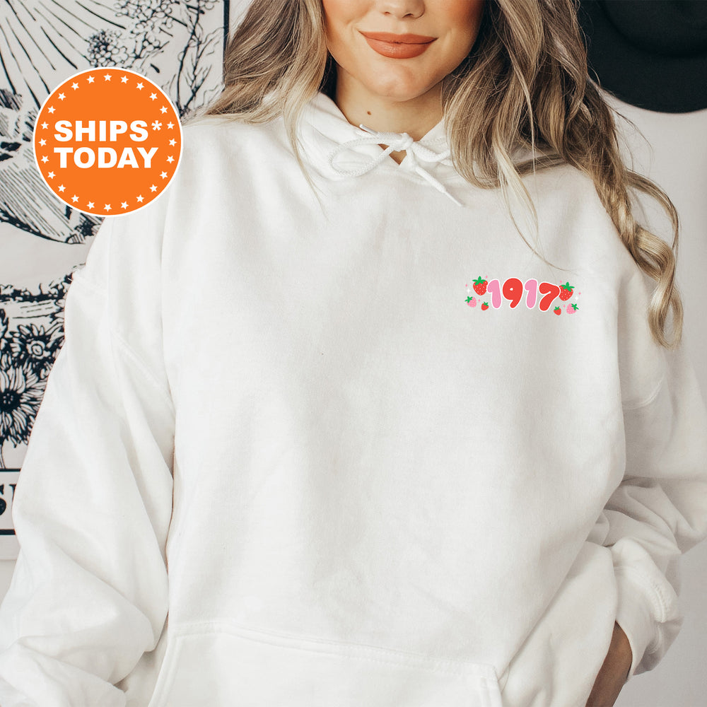 a woman wearing a white sweatshirt and a hat