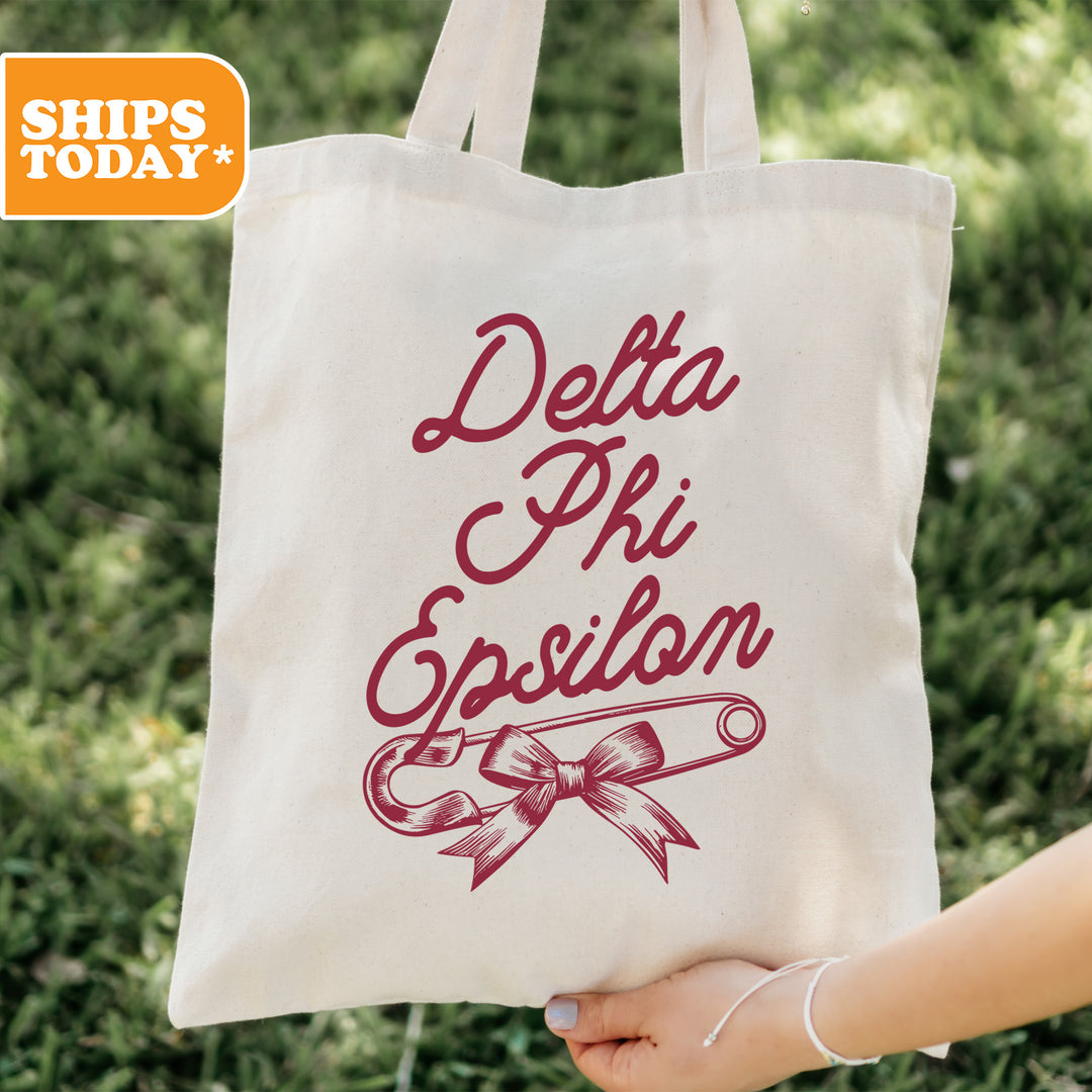 a person holding a tote bag with a design on it