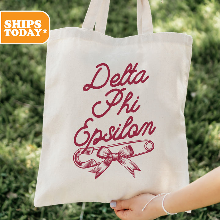 a person holding a tote bag with a design on it