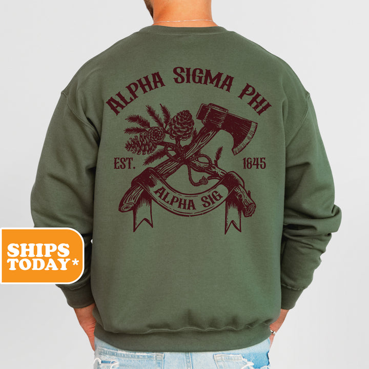 a man wearing a green sweatshirt with an image of a hammer and pine cones on