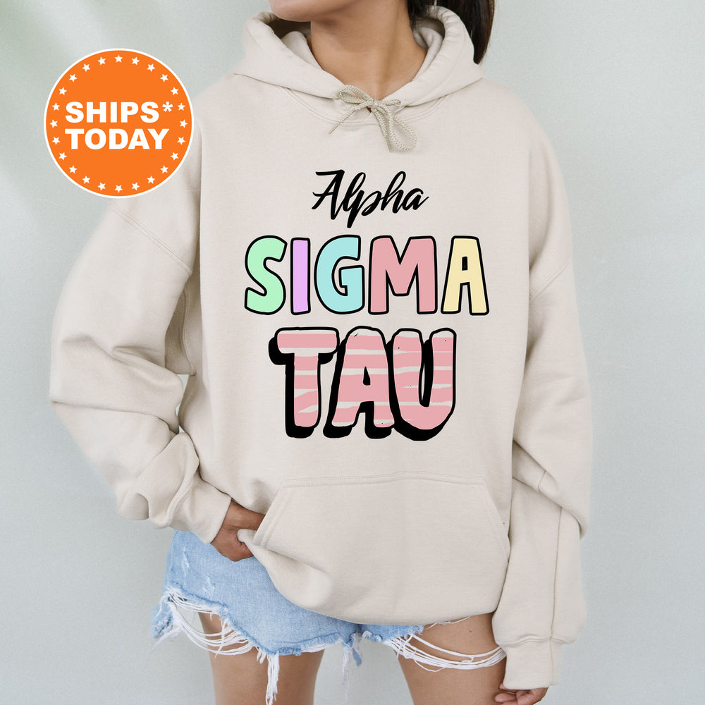 a woman wearing a sweatshirt with the words stigmaa tau on it