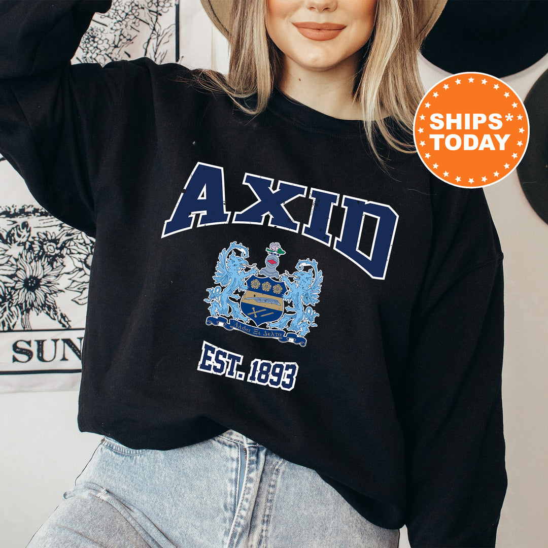 a woman wearing a black sweatshirt with an axid crest on it