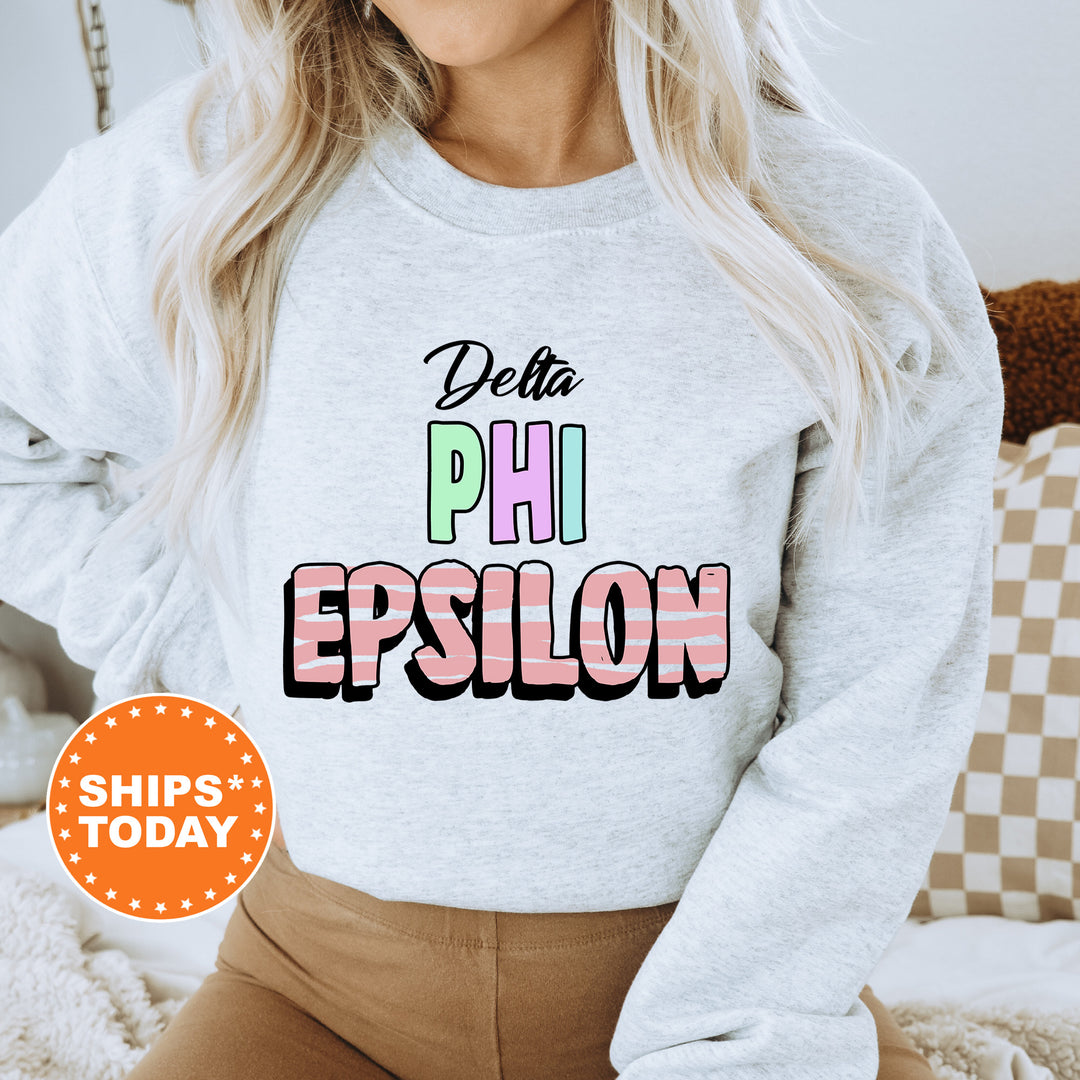 a woman wearing a sweatshirt that says delta phi epsilon