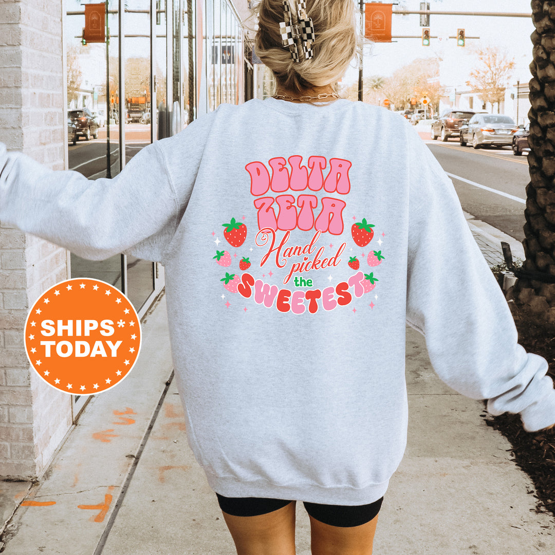 a woman walking down a sidewalk wearing a sweatshirt