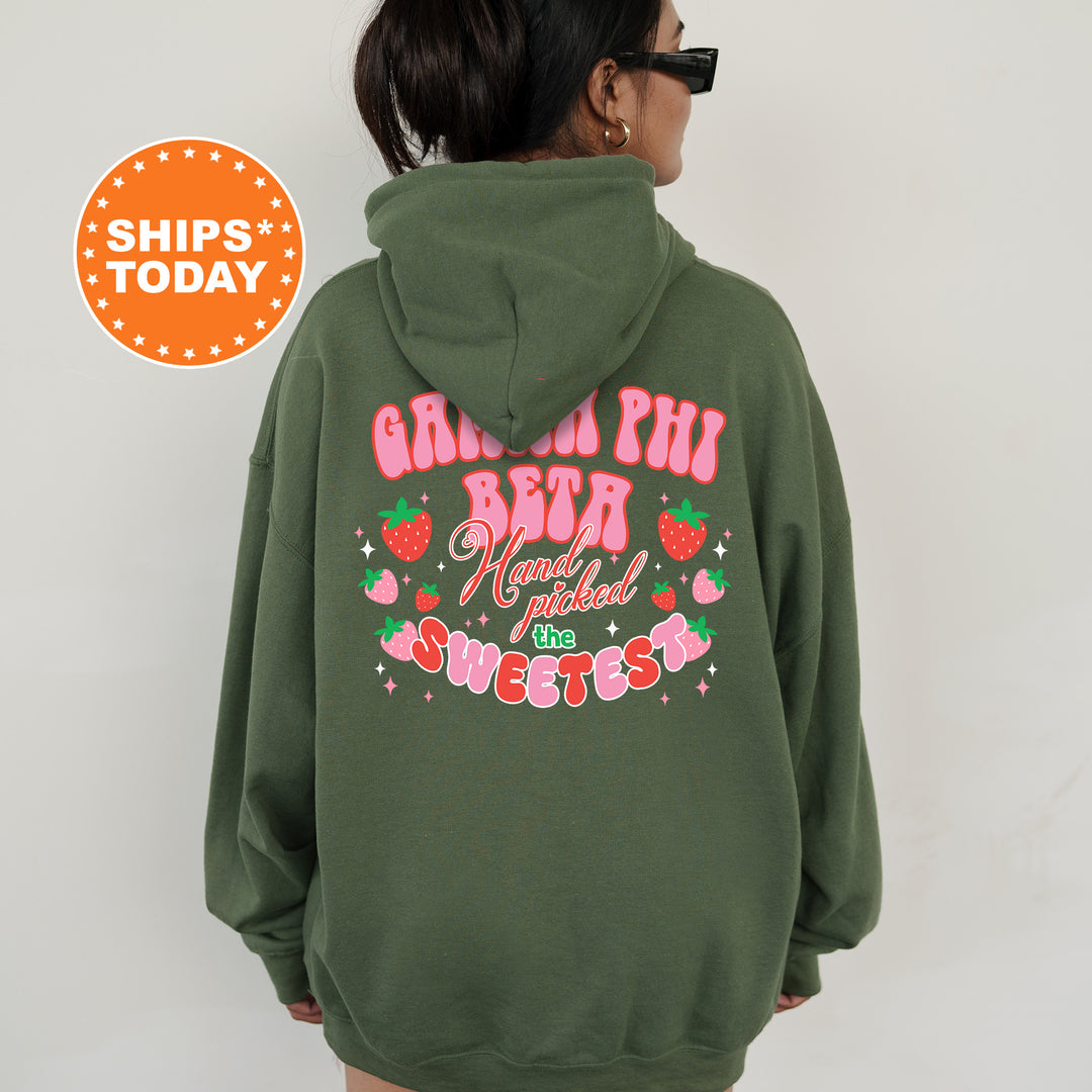 a woman wearing a green hoodie with pink lettering