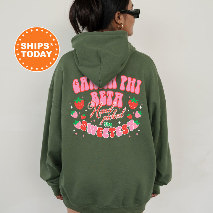 a woman wearing a green hoodie with pink lettering