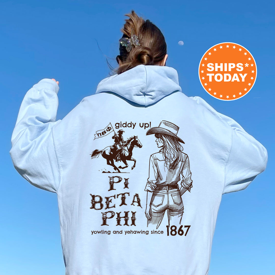 a woman wearing a white hoodie with a picture of a woman riding a horse