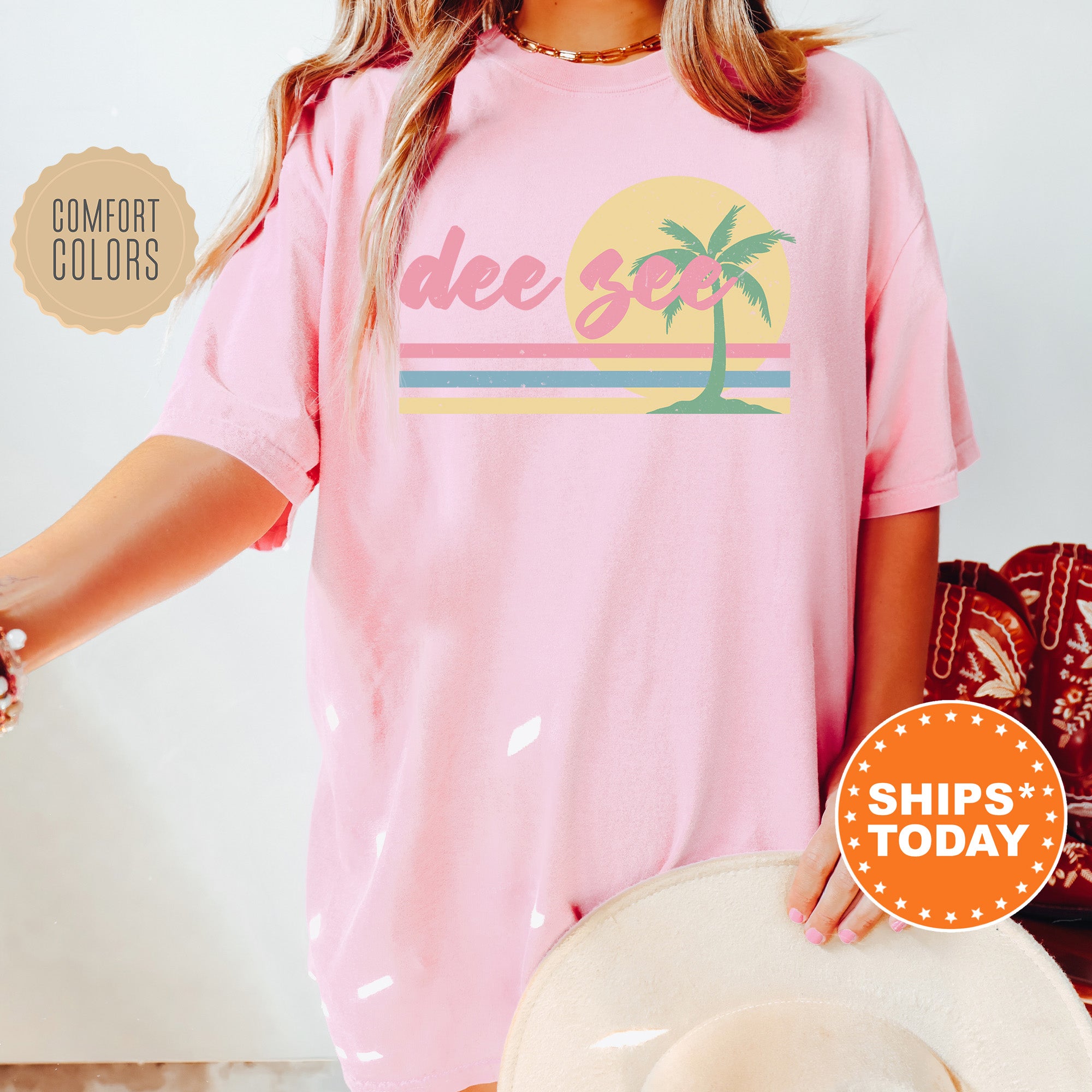 a woman wearing a pink shirt with a palm tree on it