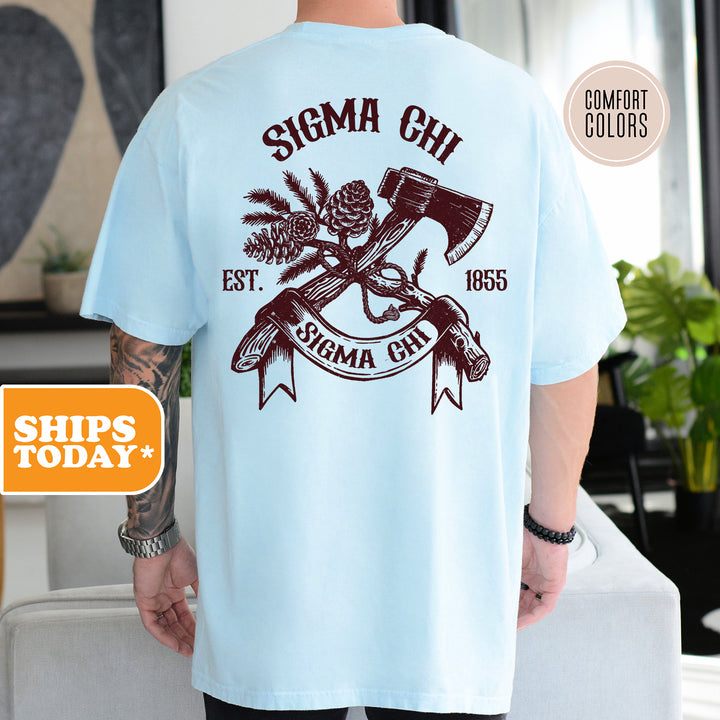 a man wearing a blue shirt with a hammer and pine tree on it