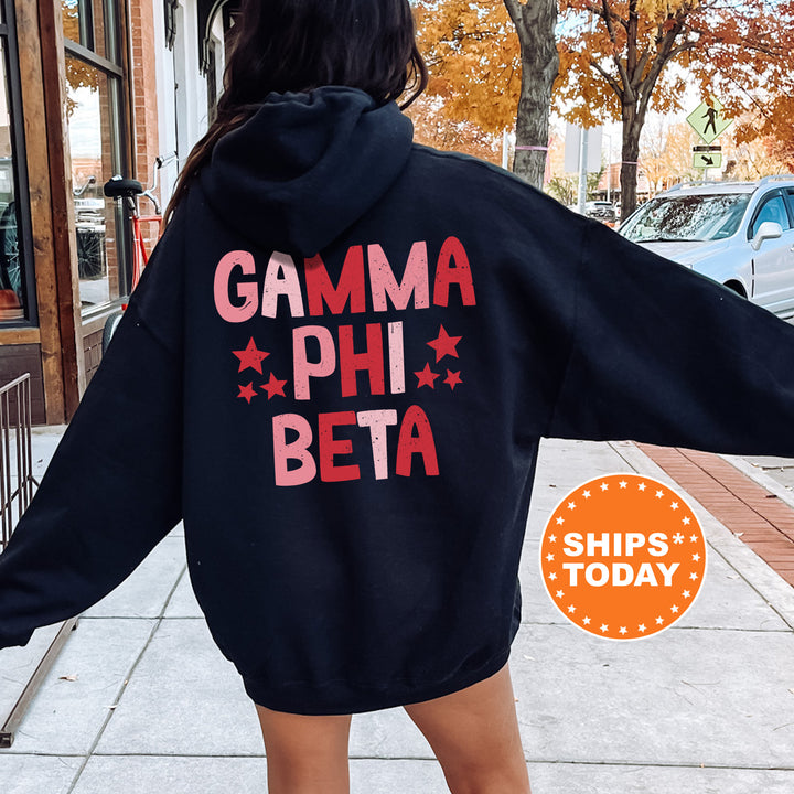 a woman in a black hoodie that says gama phi beta