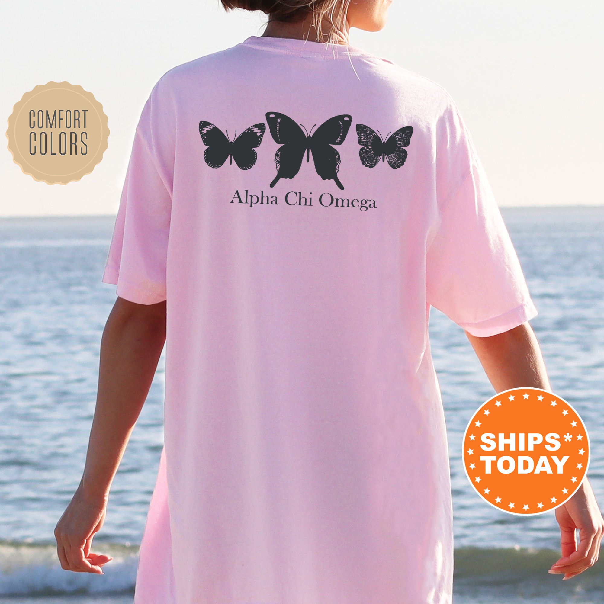 a woman wearing a pink shirt with butterflies on it