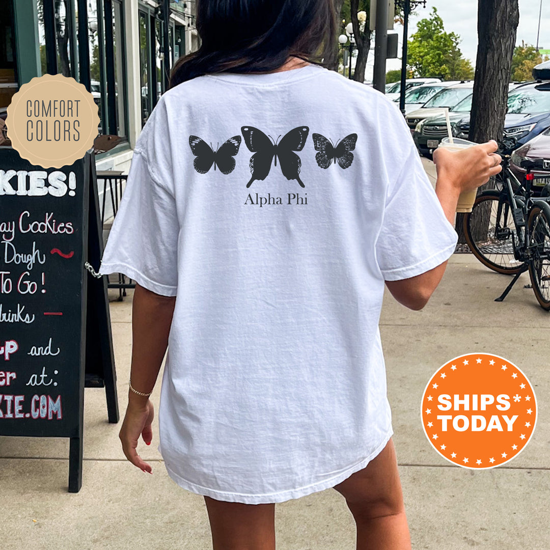 a woman walking down a sidewalk holding a donut
