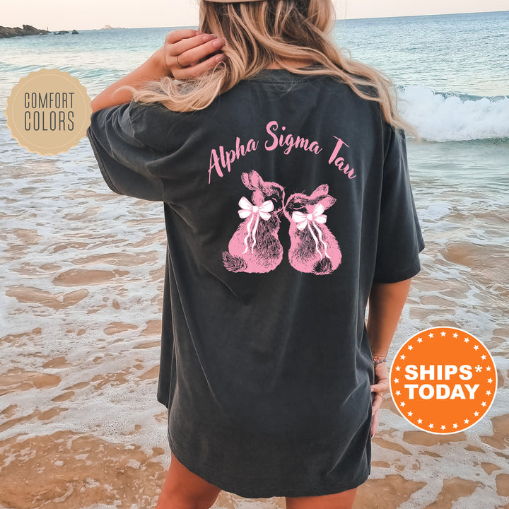 a woman standing on a beach wearing a black shirt