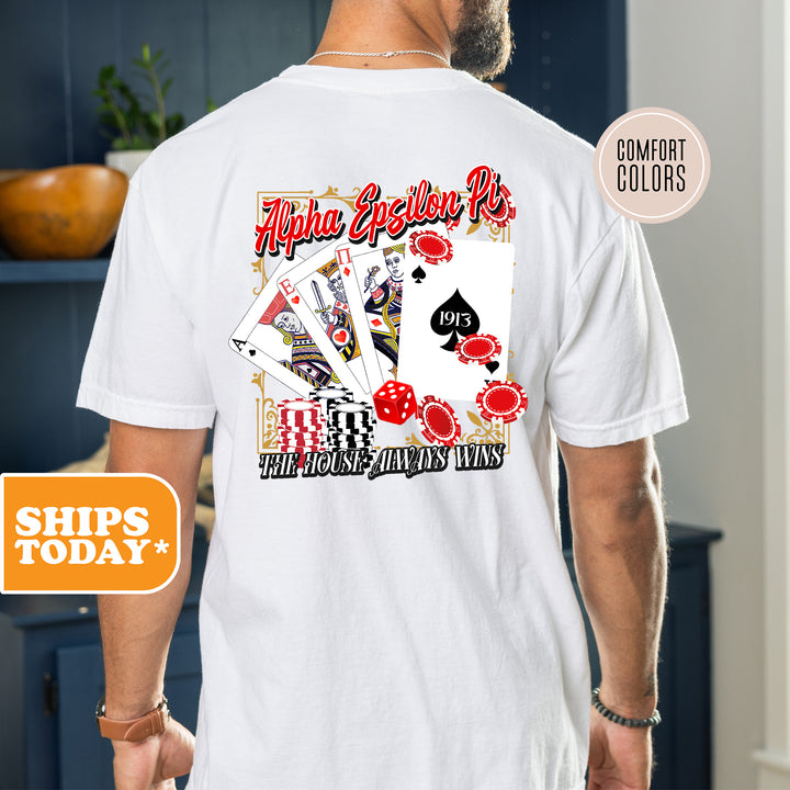 a man wearing a white t - shirt with a picture of playing cards on it