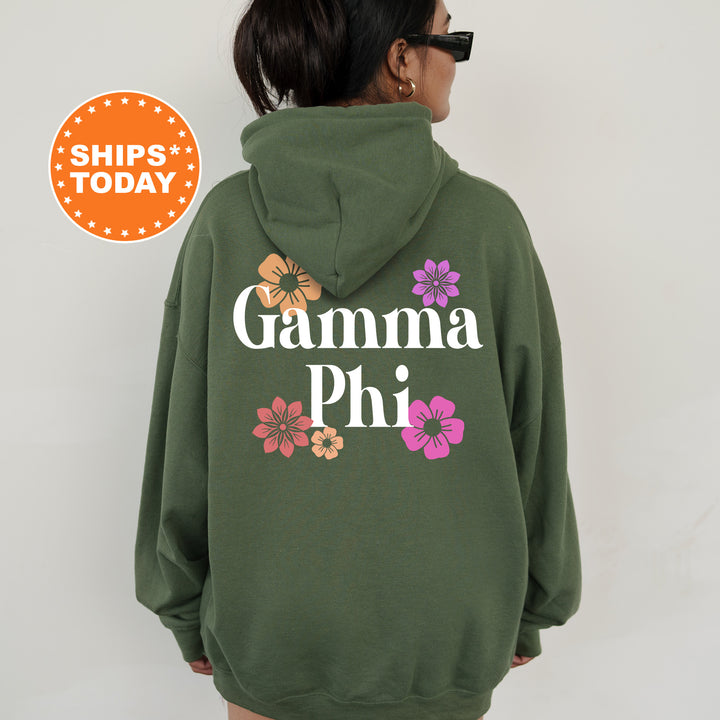 a woman wearing a green hoodie with the words gamma phi printed on it