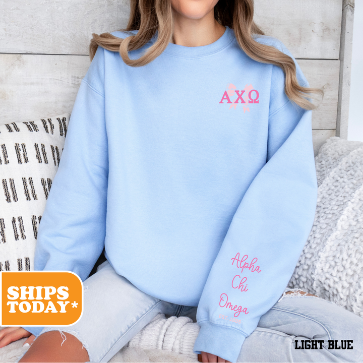a woman sitting on a bed wearing a blue sweatshirt