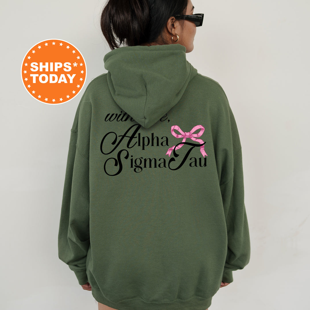 a woman wearing a green hoodie with a pink ribbon on it