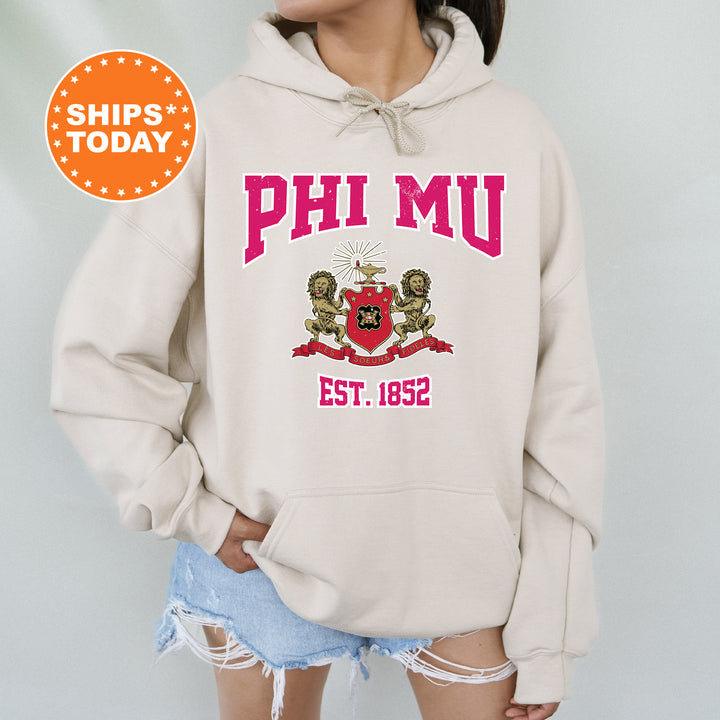 a woman wearing a hoodie with the words phi mu on it
