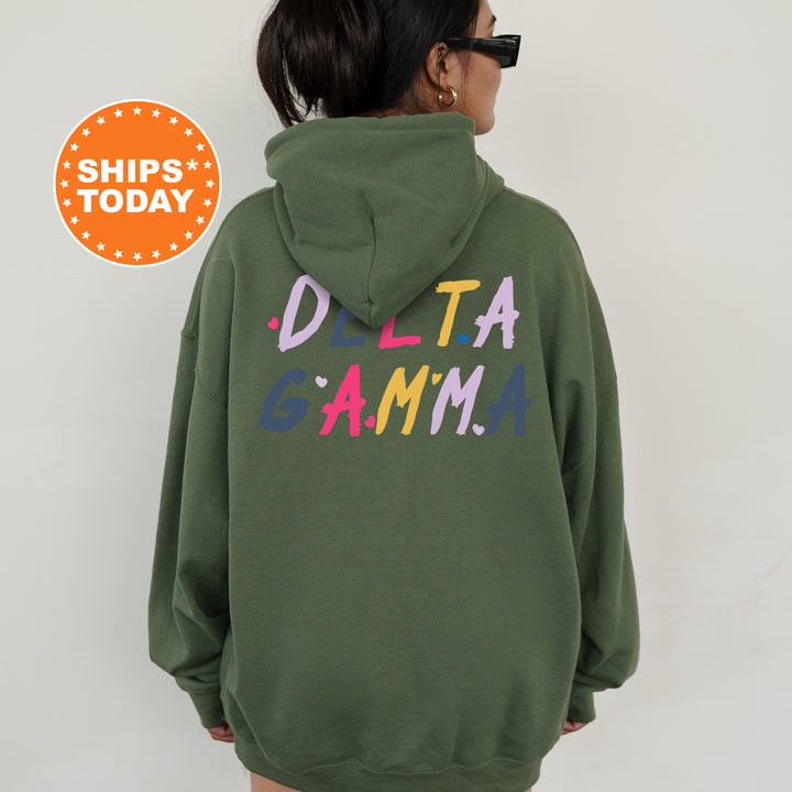 a woman wearing a green sweatshirt with the words delta gama printed on it