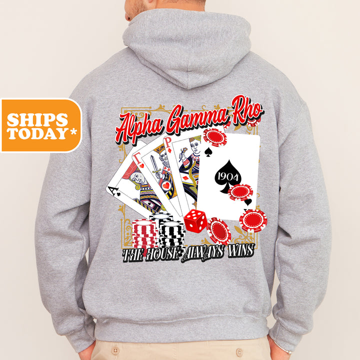 a man wearing a hoodie with a picture of playing cards on it