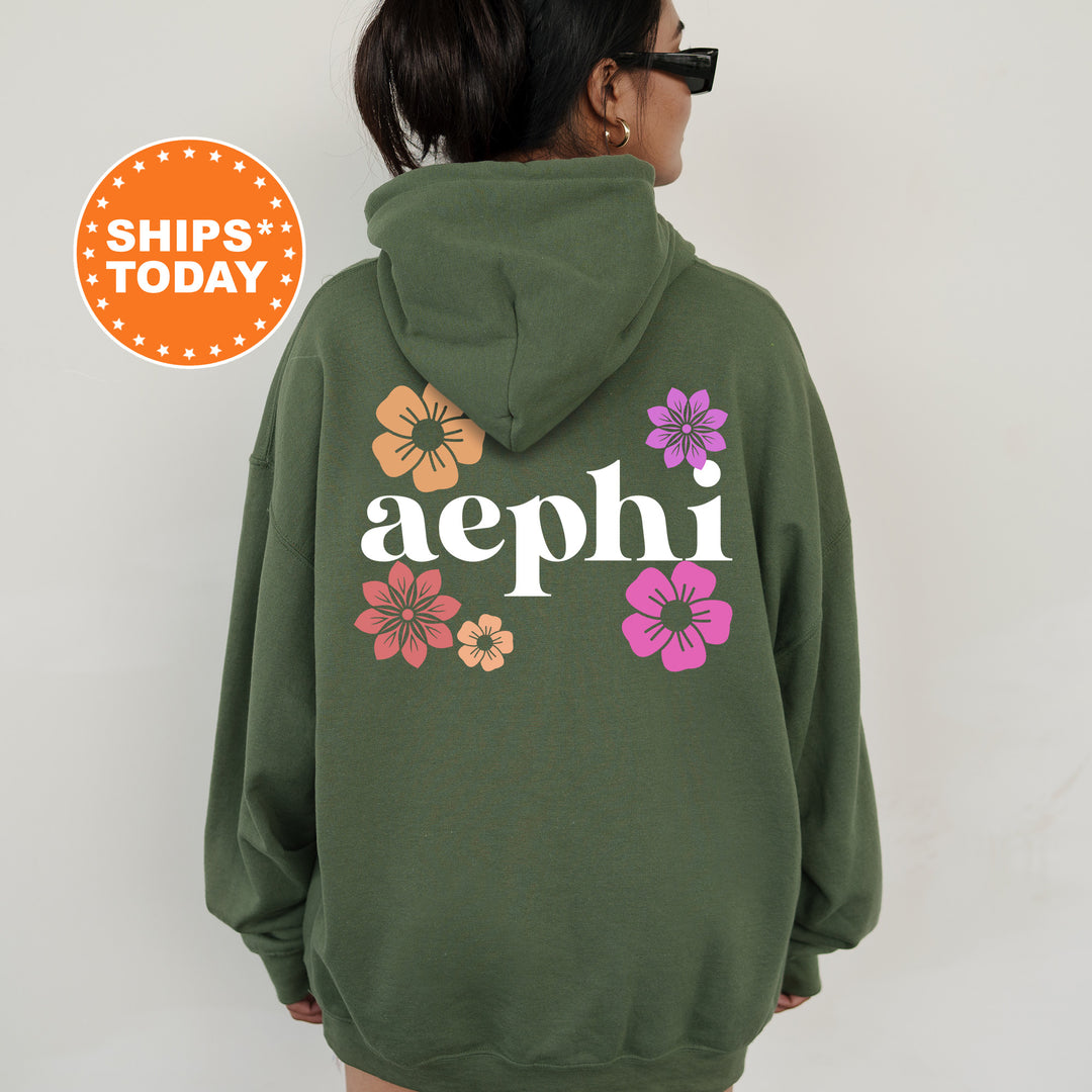 a woman wearing a green hoodie with flowers on it