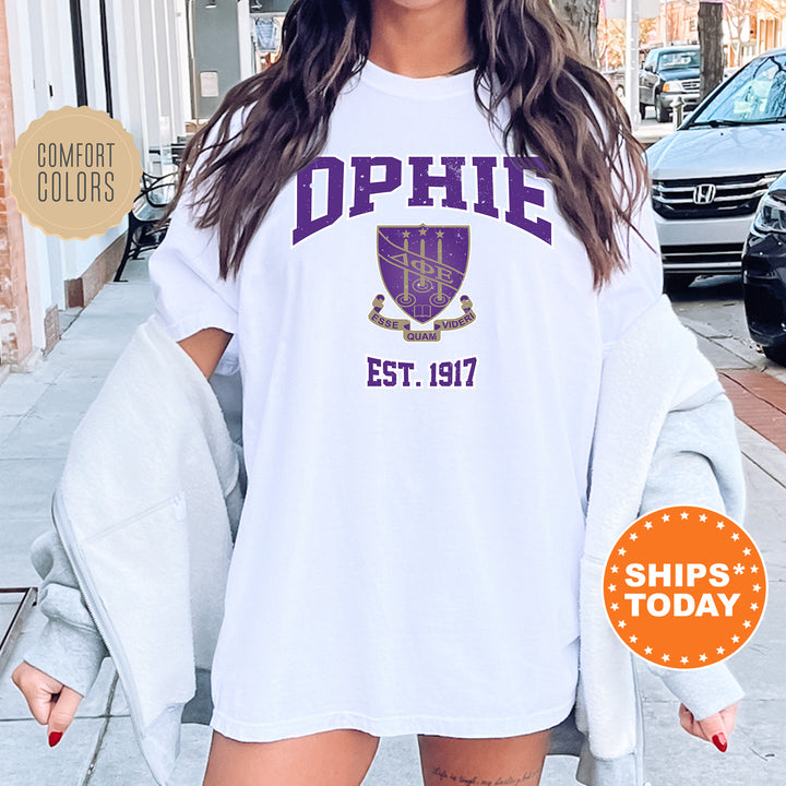 a woman wearing a white shirt with purple letters on it