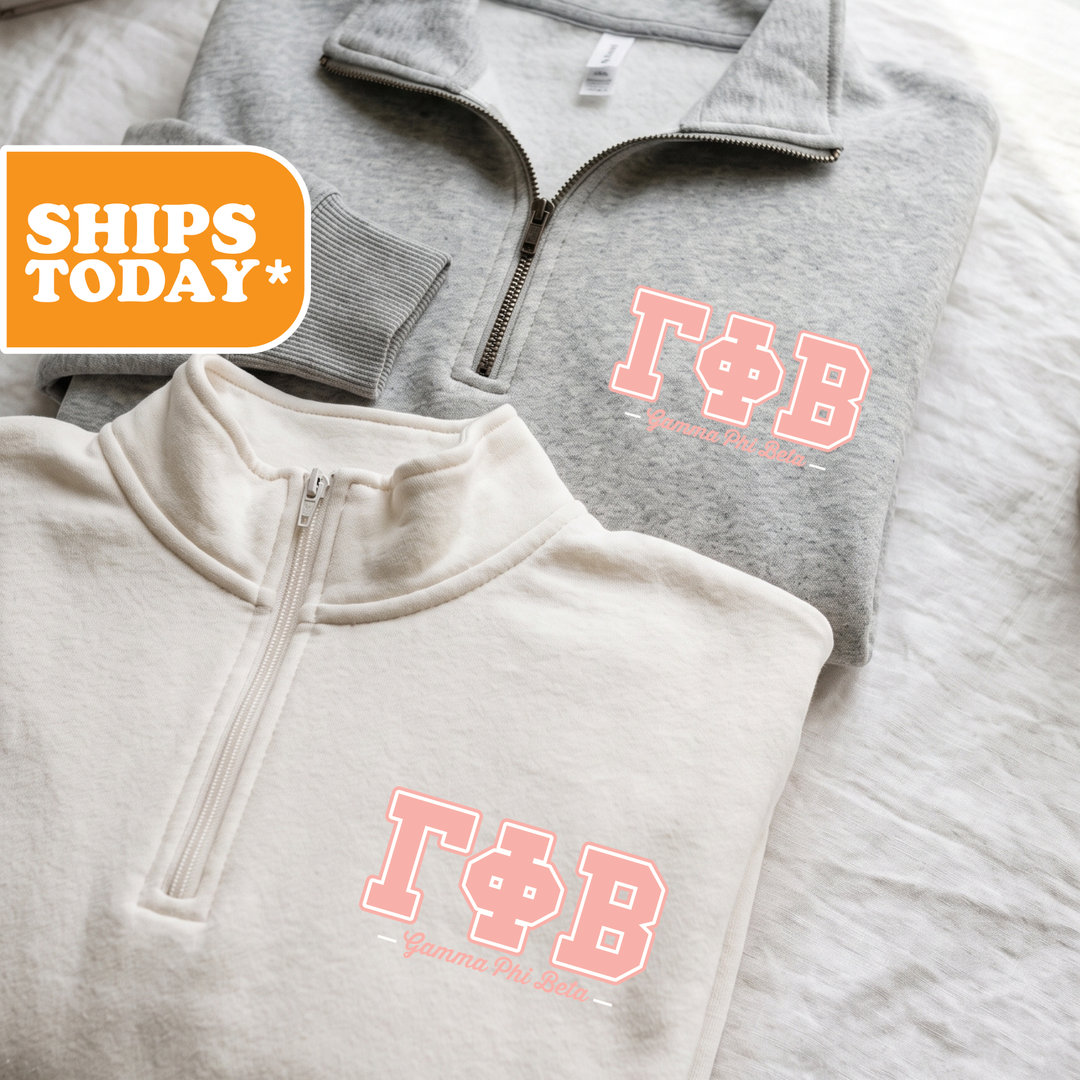 Two gray sweatshirts with the Greek letters 'ΦΑ' printed on them, along with the text 'ΤΑΓΟΡΕΙΑ' and 'ΤΑΓΟΡΕΙΑ' printed on them.