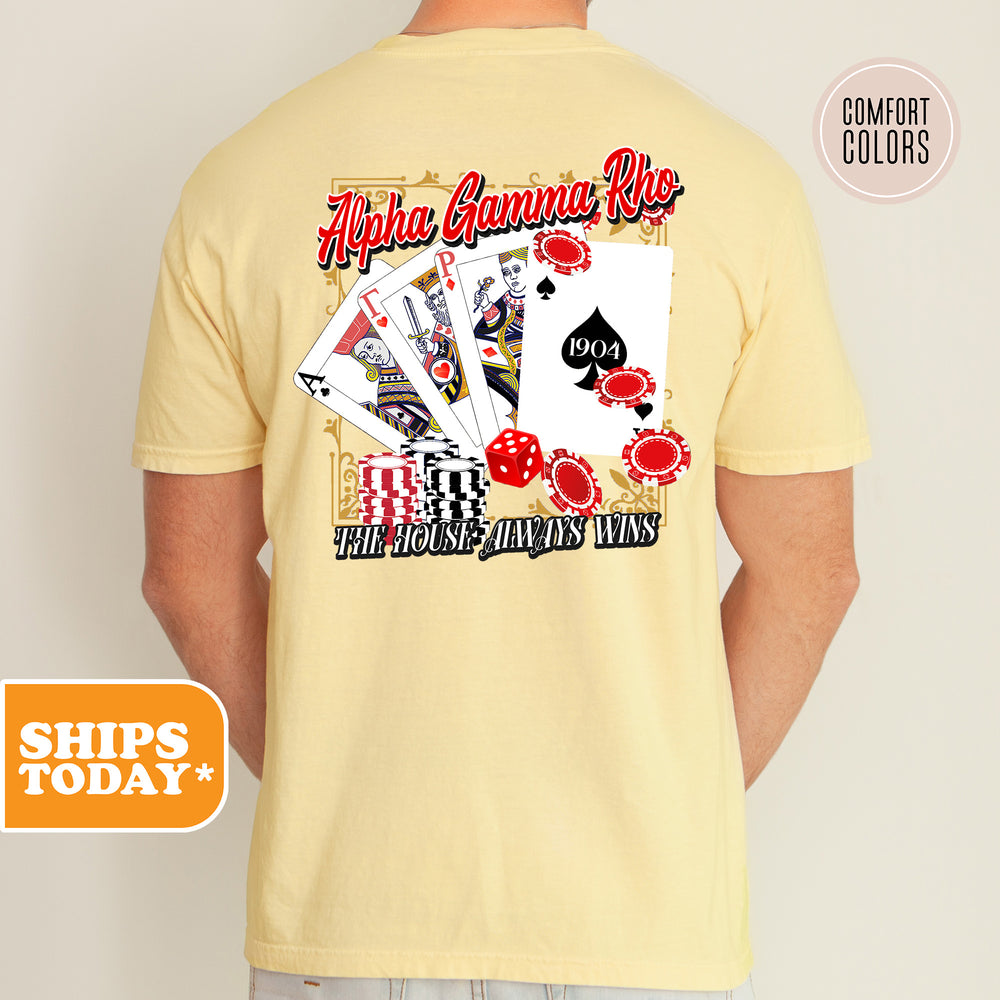 a man wearing a t - shirt with a picture of playing cards on it