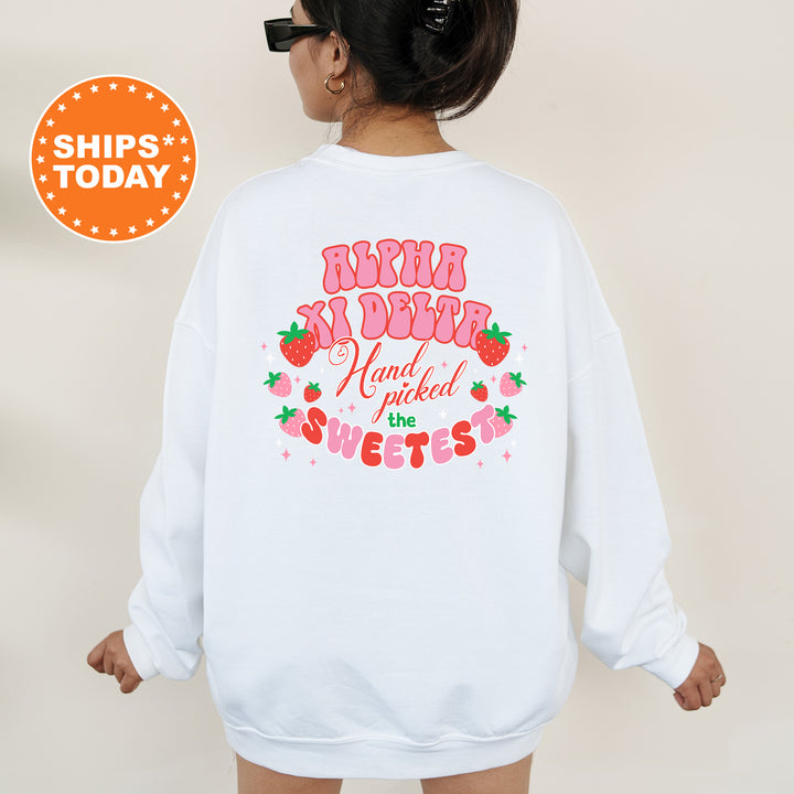 a woman wearing a white sweatshirt with a strawberry print on it