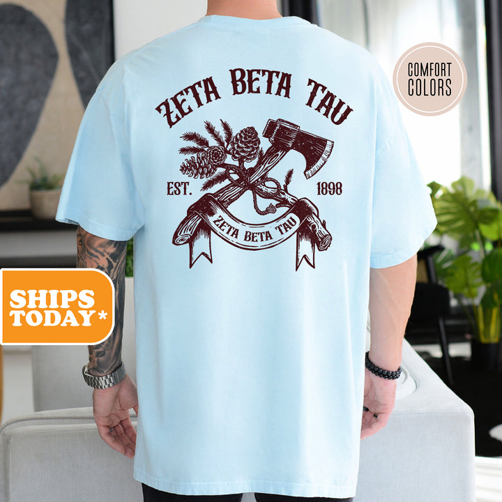 a man wearing a blue t - shirt with an image of a hammer and a