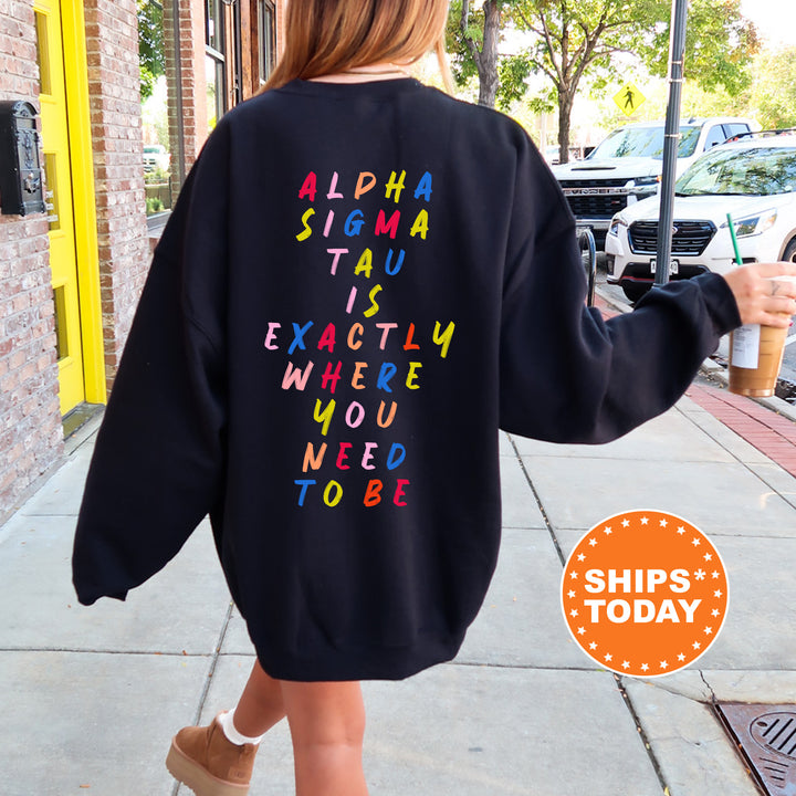 a woman walking down a sidewalk wearing a black sweatshirt