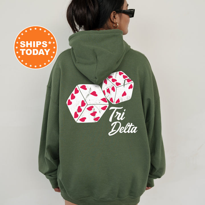 a woman wearing a green hoodie with a pair of dice on it