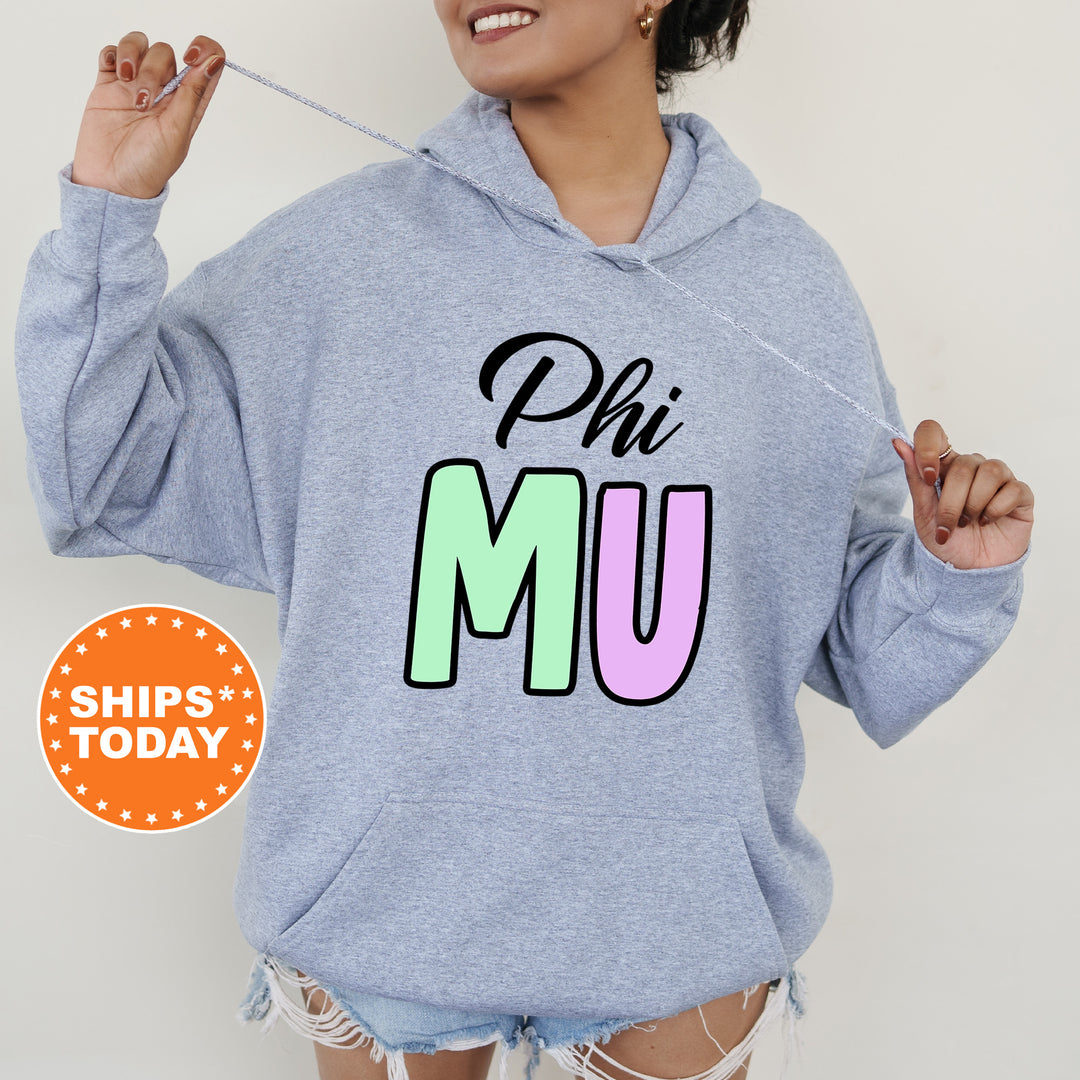 a woman wearing a sweatshirt that says phi mu